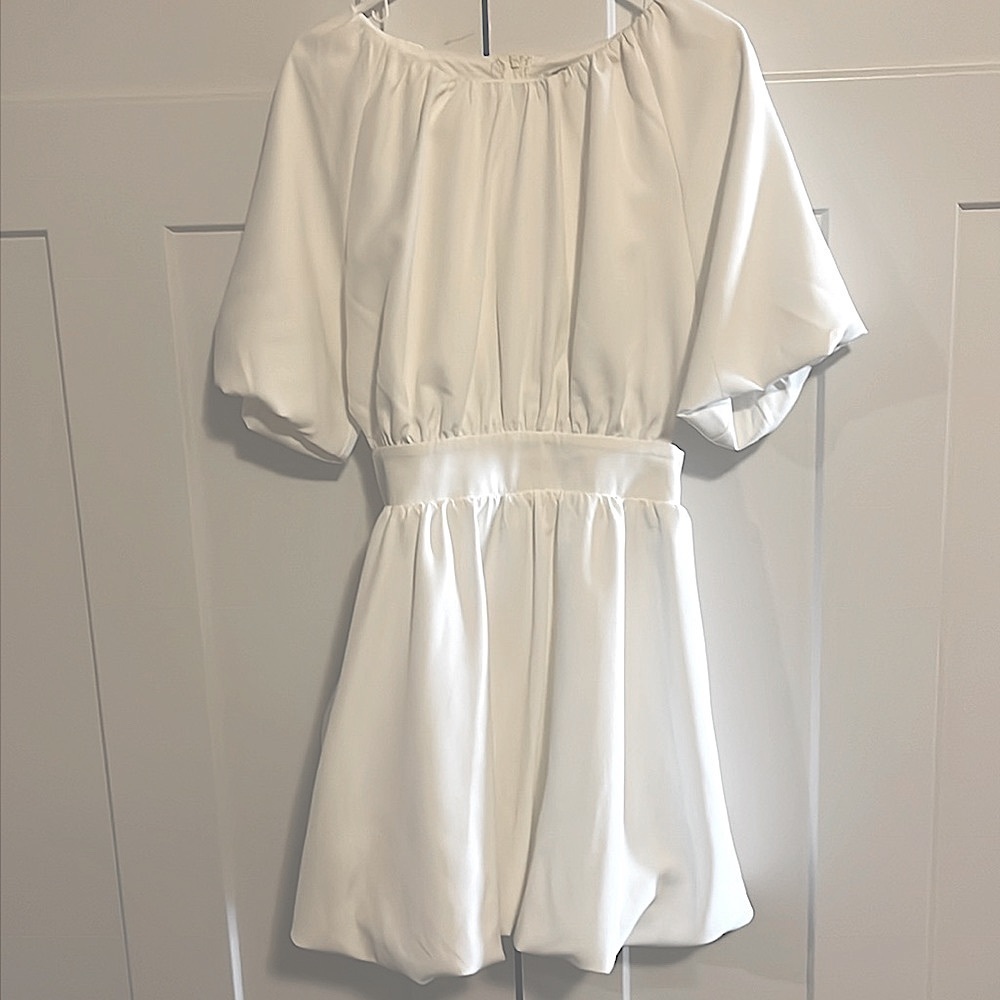 Flowy white puffy dress with side cut outs.